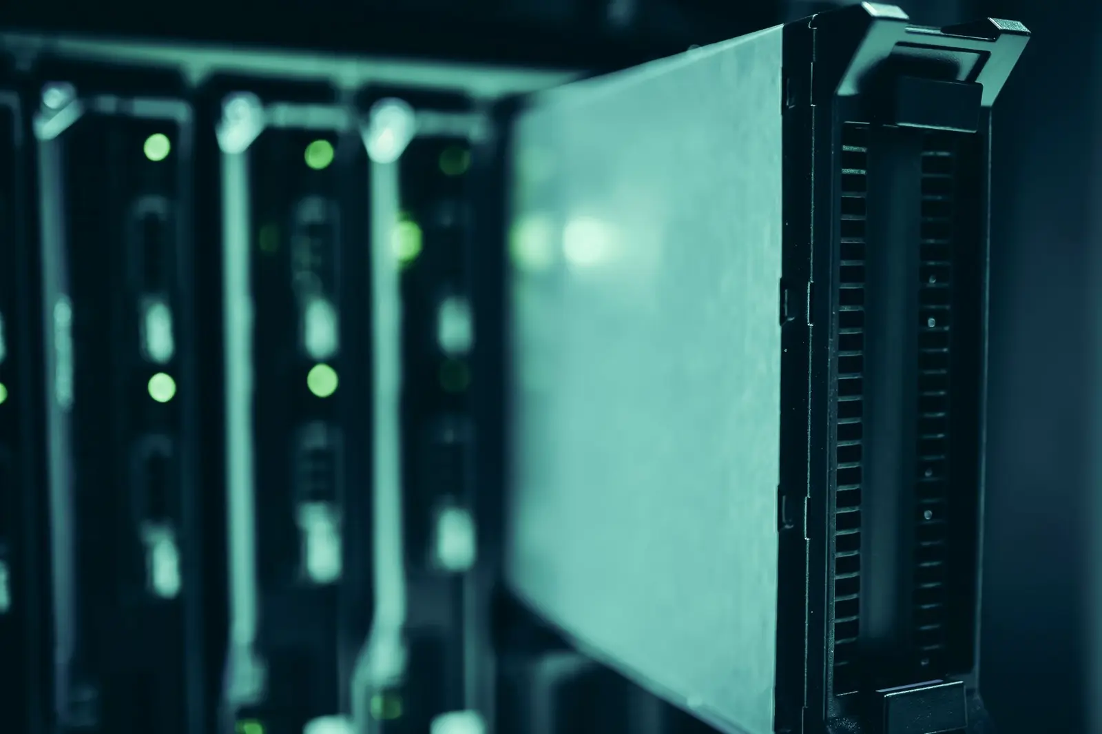 Close-up of a blue-lit server rack in a data center.